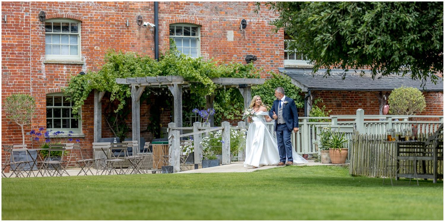 Wedding venue exterior features classic brick architecture and garden setting.
