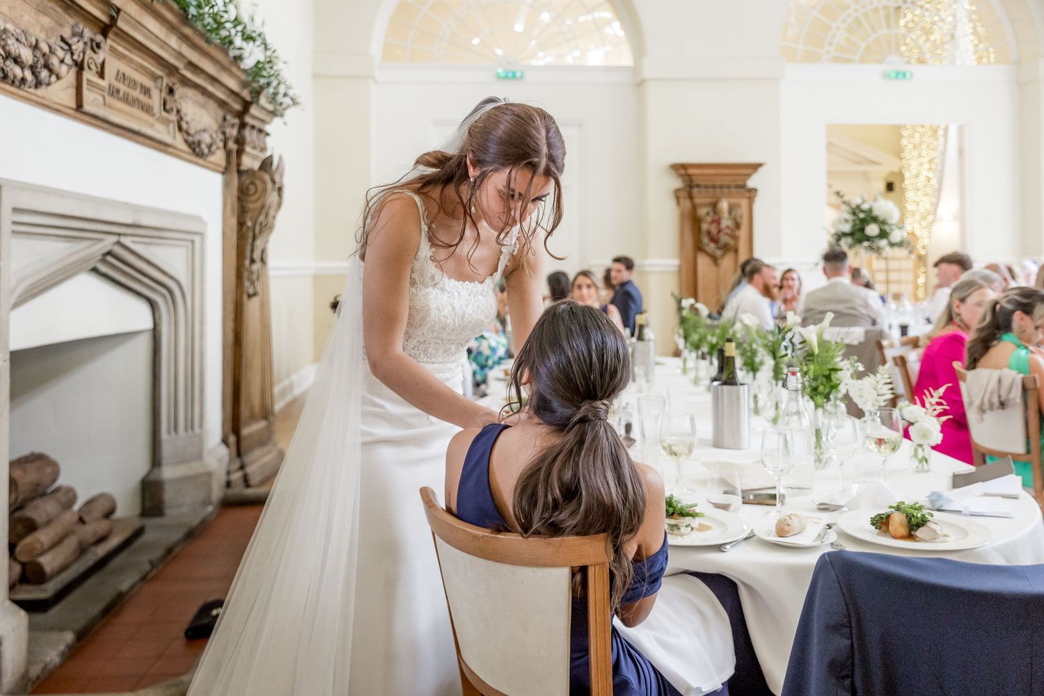 Elegant wedding reception venue with ornate decor and table settings for guests.