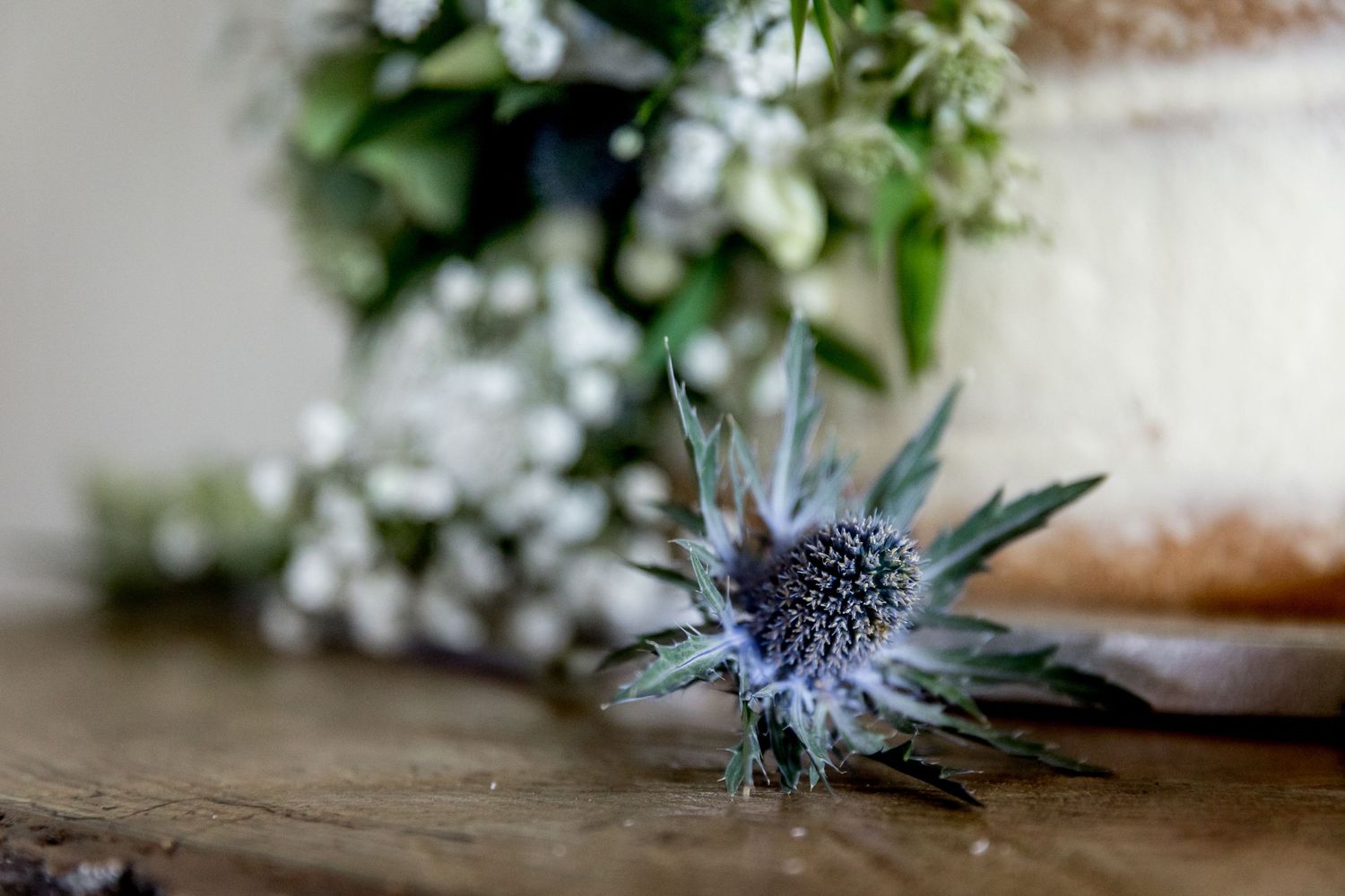 Decorative blue thistle and white floral arrangements add natural elegance to wedding decor.