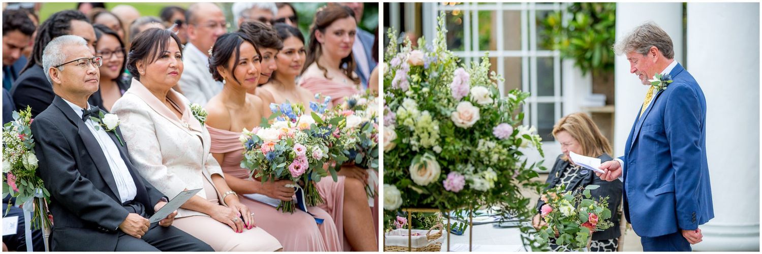 Wedding guests gather outdoors for a celebration on a sunny day with white floral arrangements.