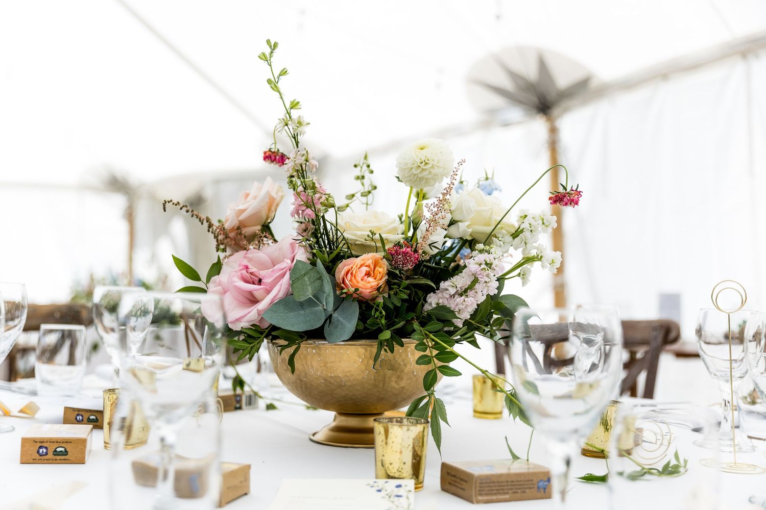 Wedding photograph f a table centrepiece in the dining marquee at Houghton Lodge near Stockbridge.
