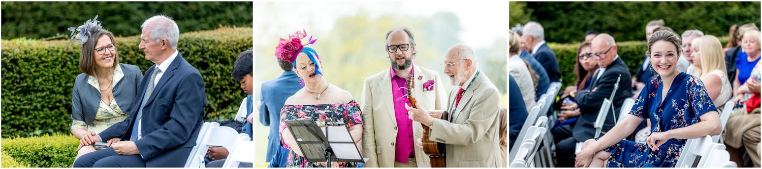 Wedding guests mingle and celebrate on a sunny outdoor garden terrace.