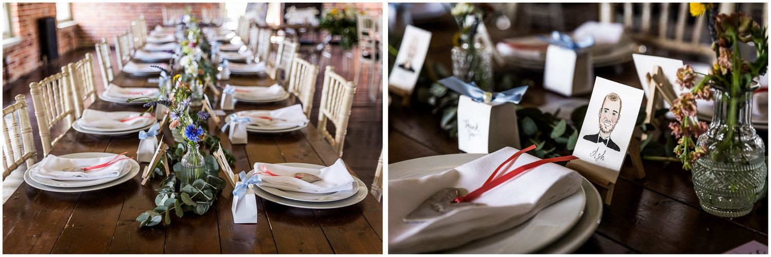 Elegant rustic wedding reception table setting with floral centerpieces, white plates, and decorative place cards on a wooden table.