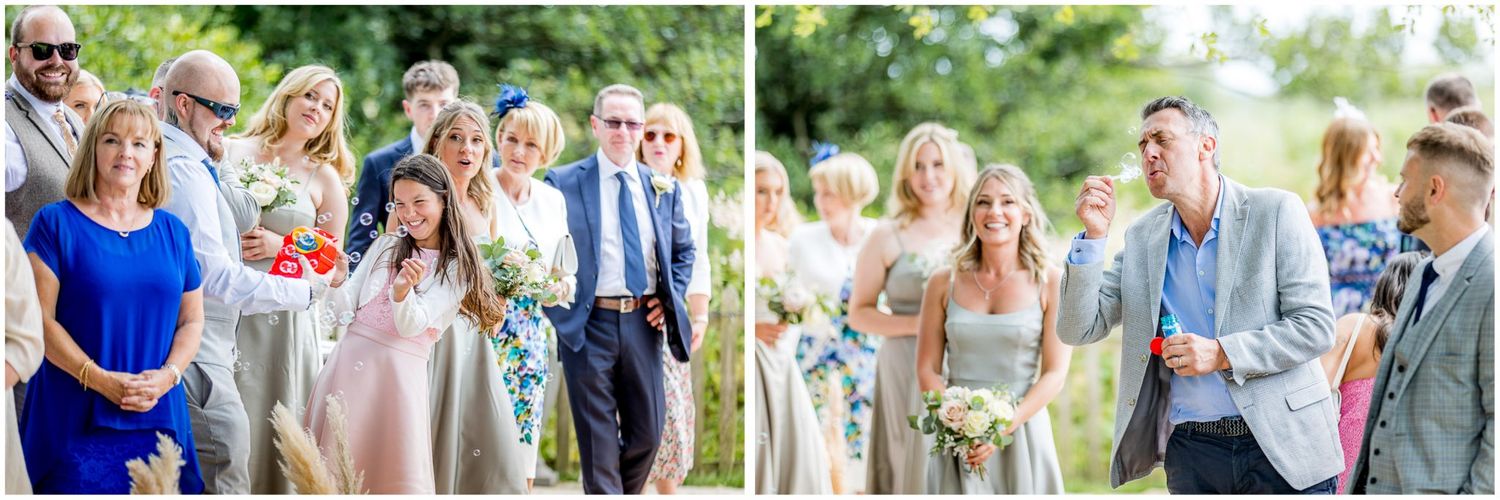 Guests mingle and celebrate during outdoor wedding reception with natural lighting.