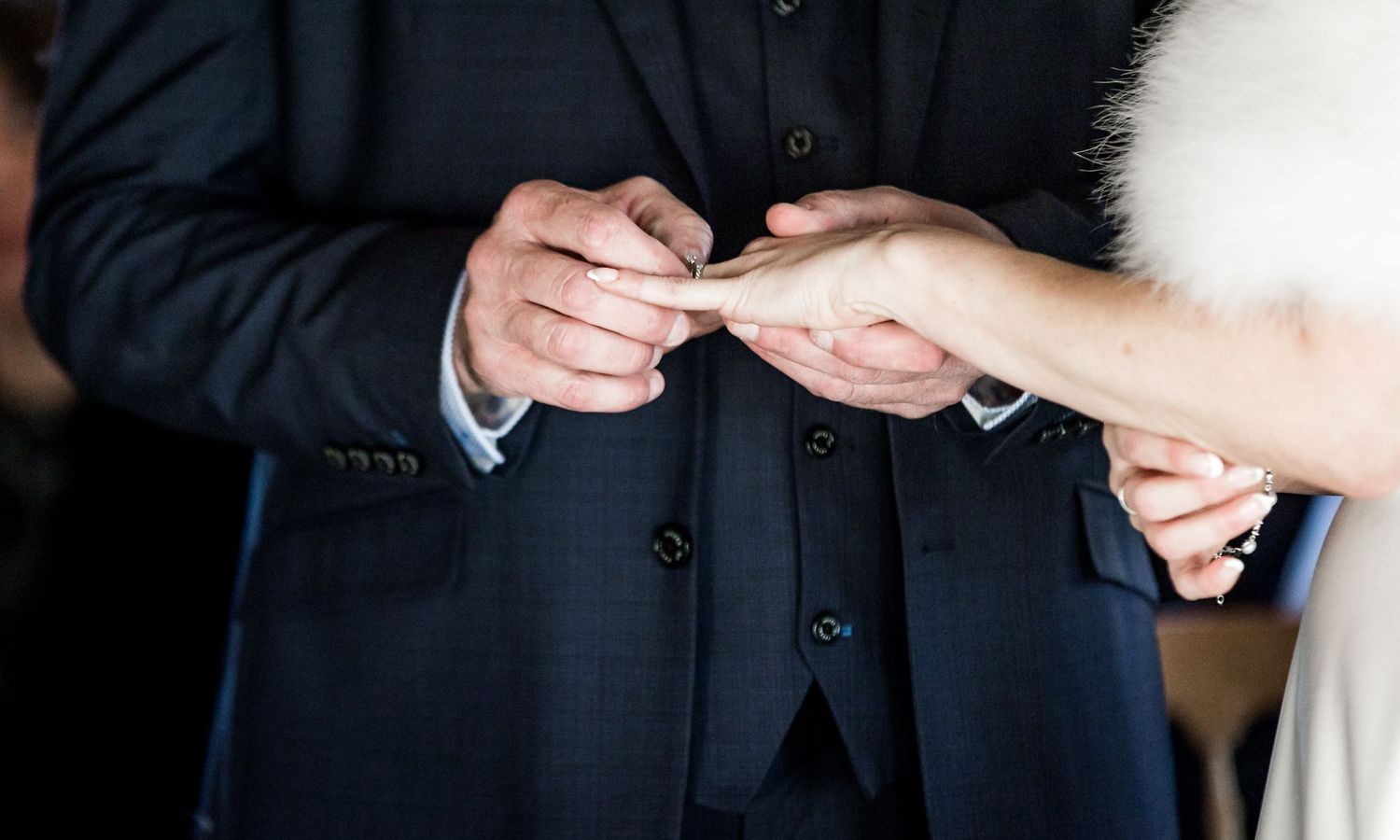The exchange of rings during the marriage ceremony at Clock barn