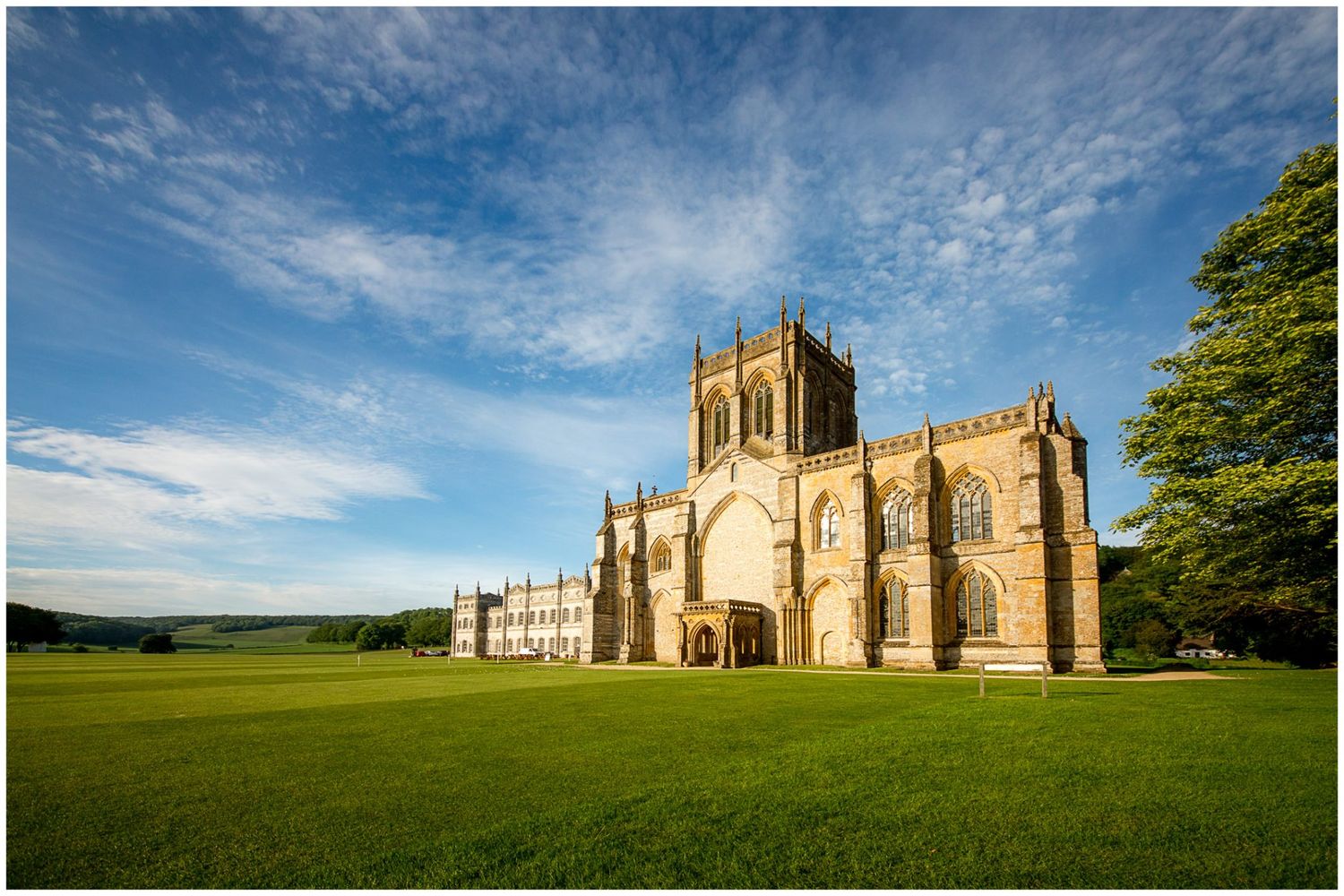 Historic Milton Abbey church and grounds in Dorset shown in a panoramic series of connected landscape photographs.