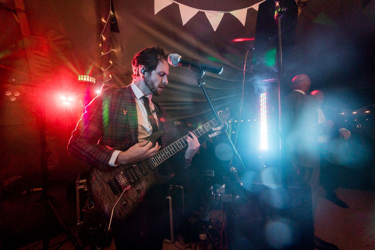 Atmospheric nightclub scene with colorful red and blue lighting effects illuminating the dance floor.