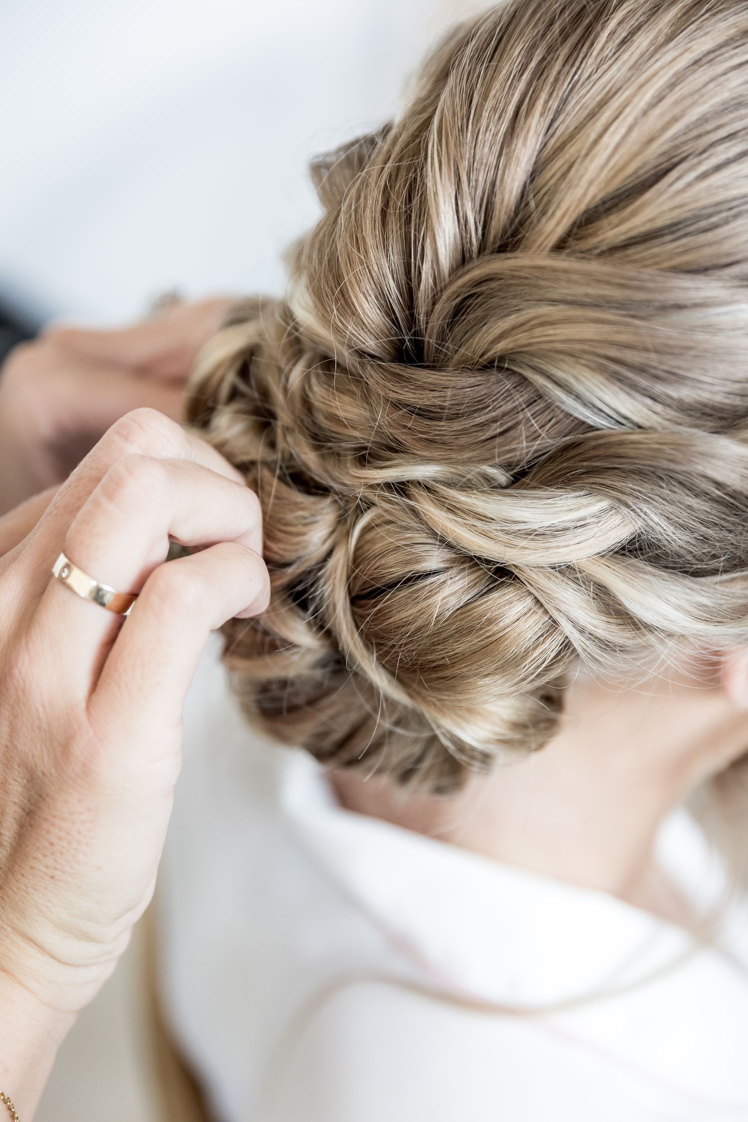 Step by step process of creating an elegant braided updo hairstyle.