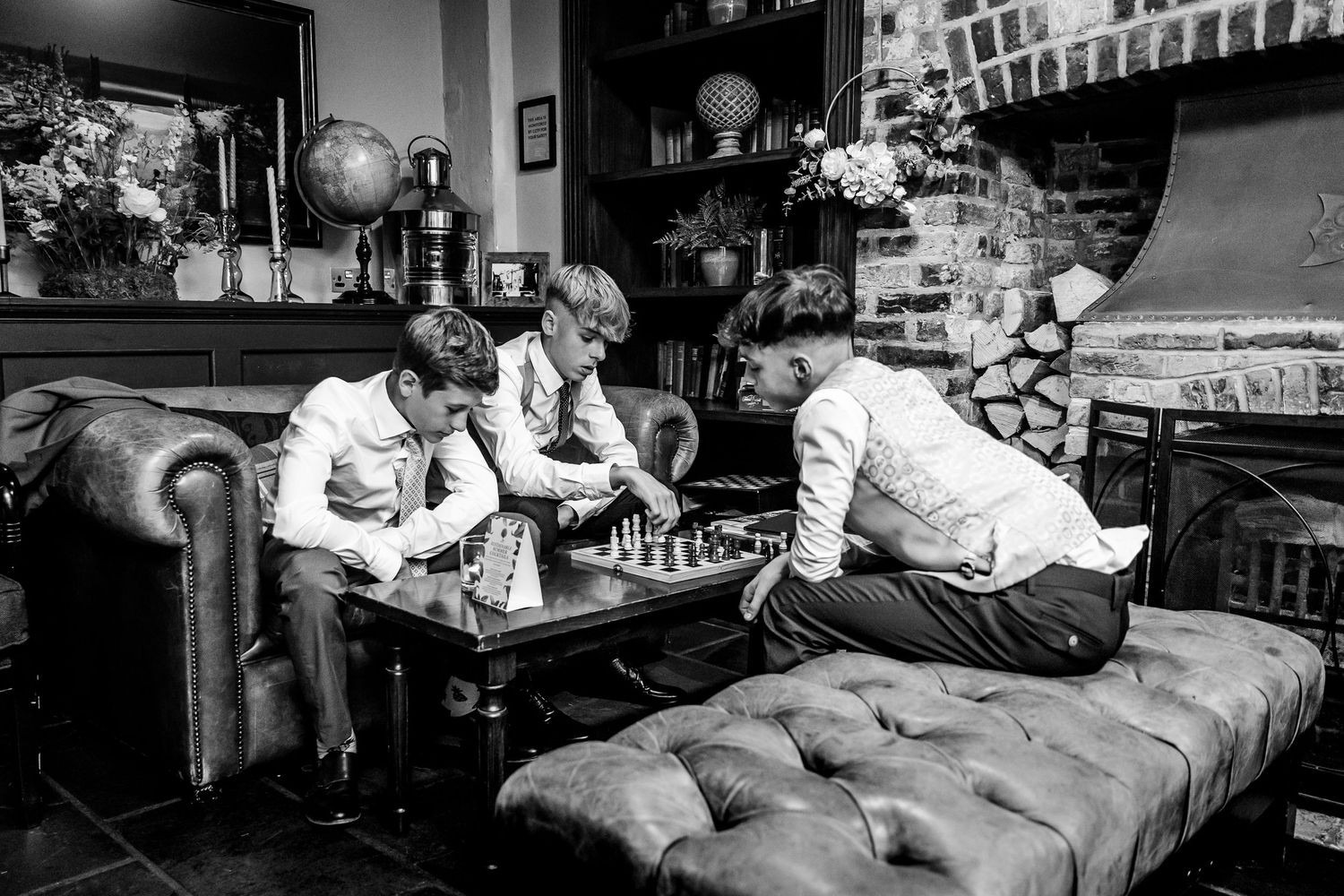 Black and white photos showing a relaxed gathering in a cozy living room setting.