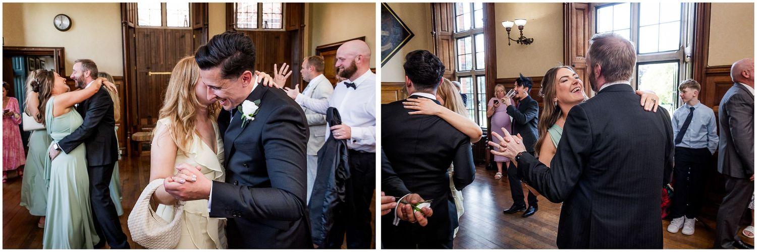 A group of wedding guests dancing and celebrating together on a dance floor at an elegant indoor reception.