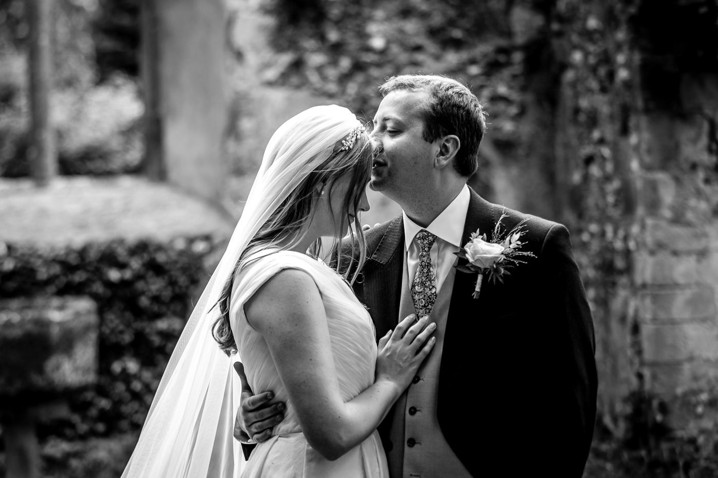 Black and white romantic moments captured in a garden setting.