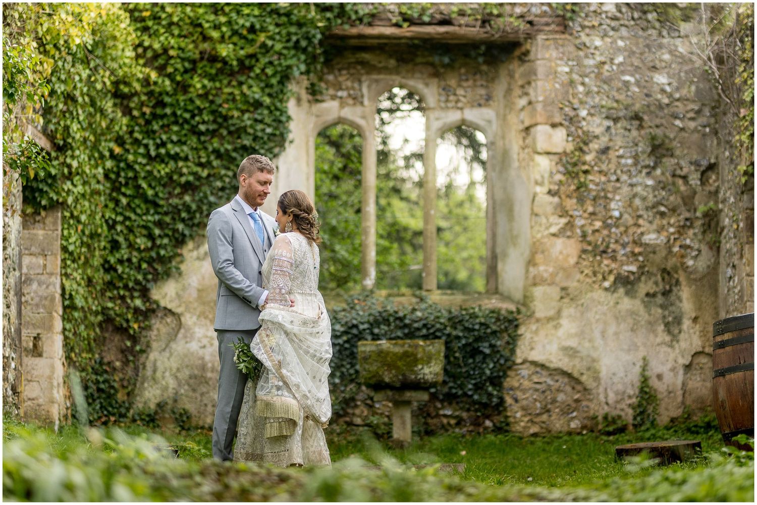 Romantic wedding photos taken against old stone walls covered in ivy.