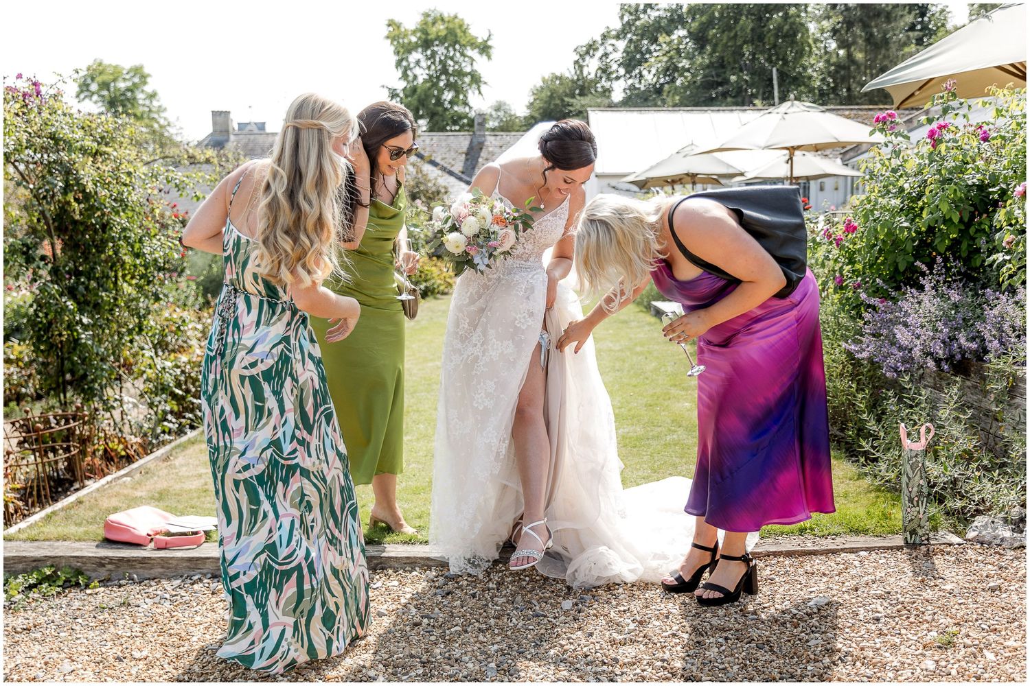 Wedding celebration in blooming garden with guests mingling among flowers.