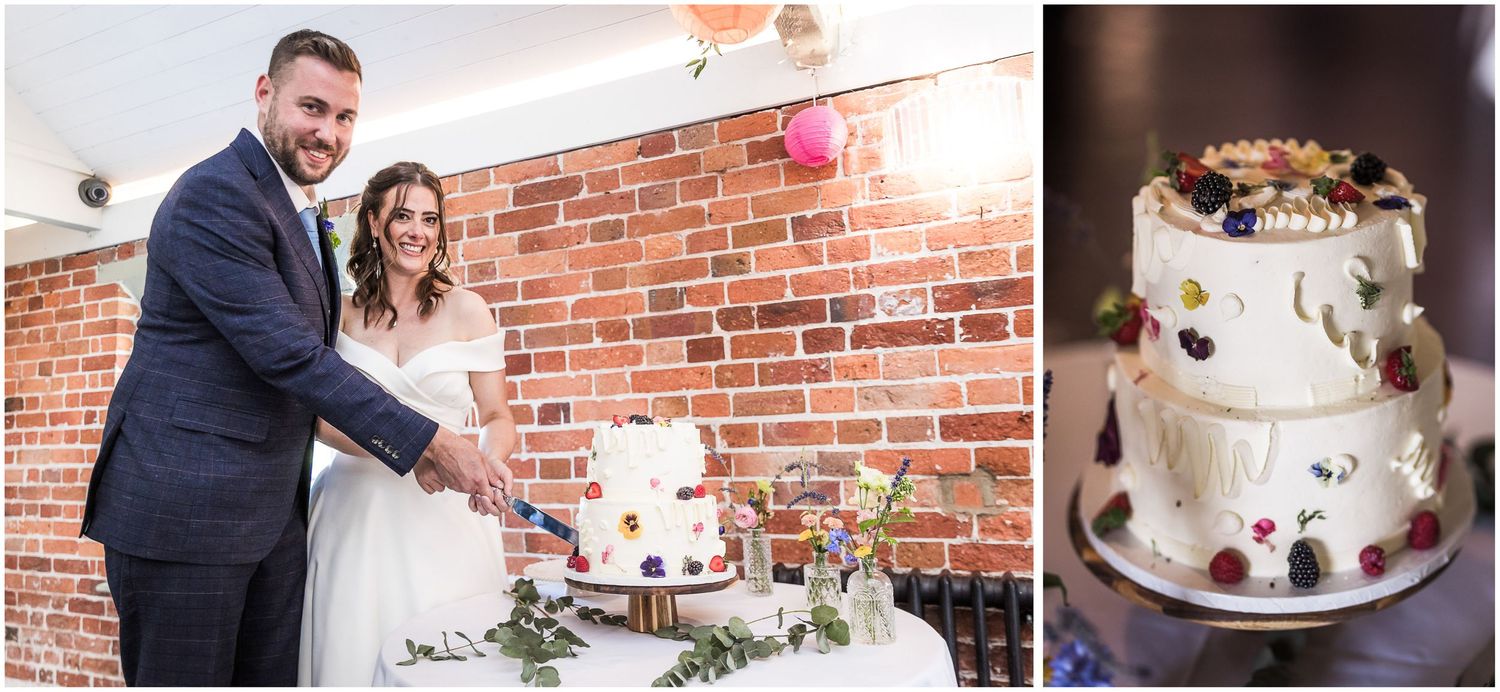 Bride and groom cutting a white wedding cake decorated with berries in the dining room at Sopley Mill.