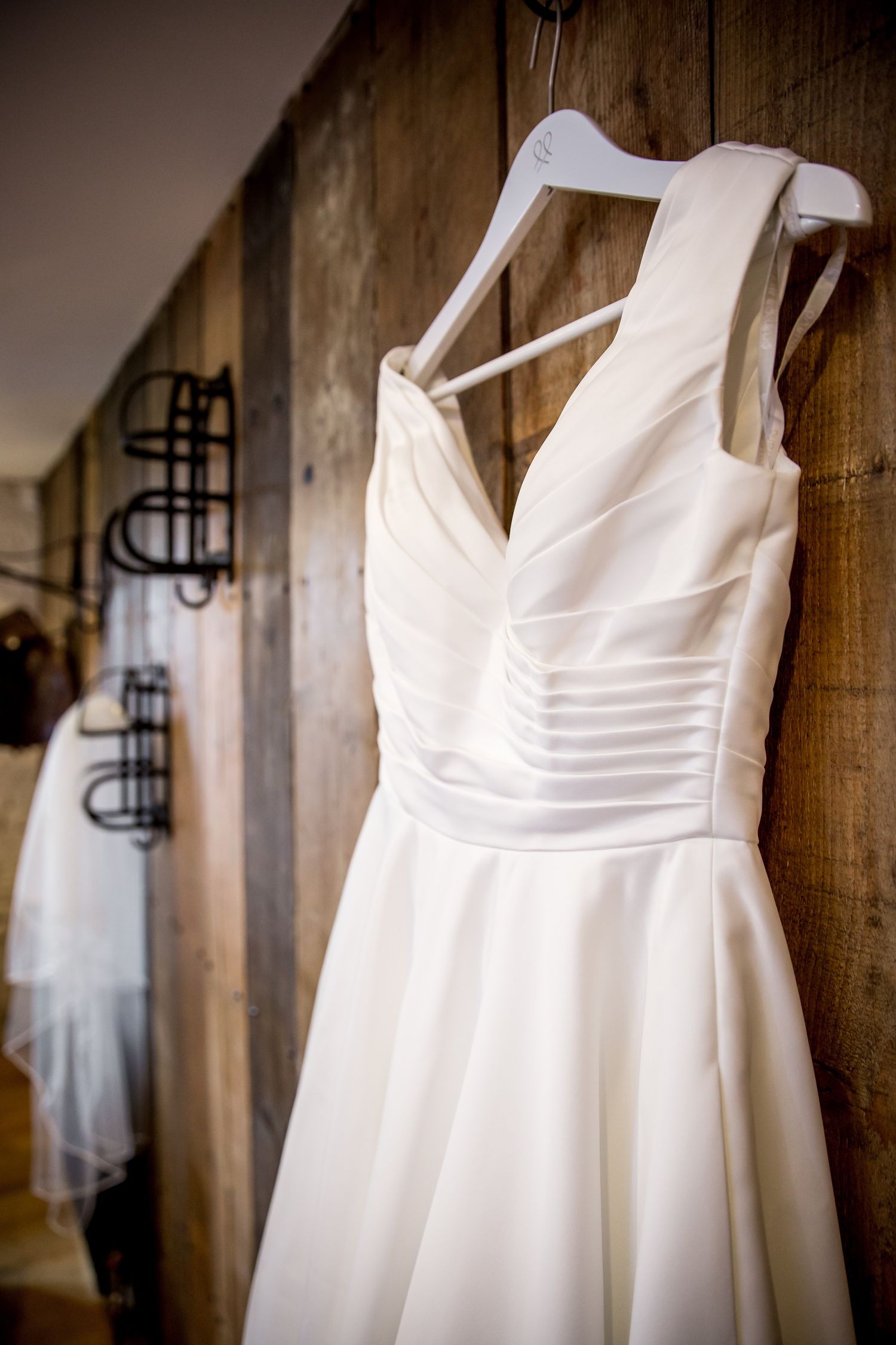 A wedding dress hanging in the bridal preparation suite at Clock Barn