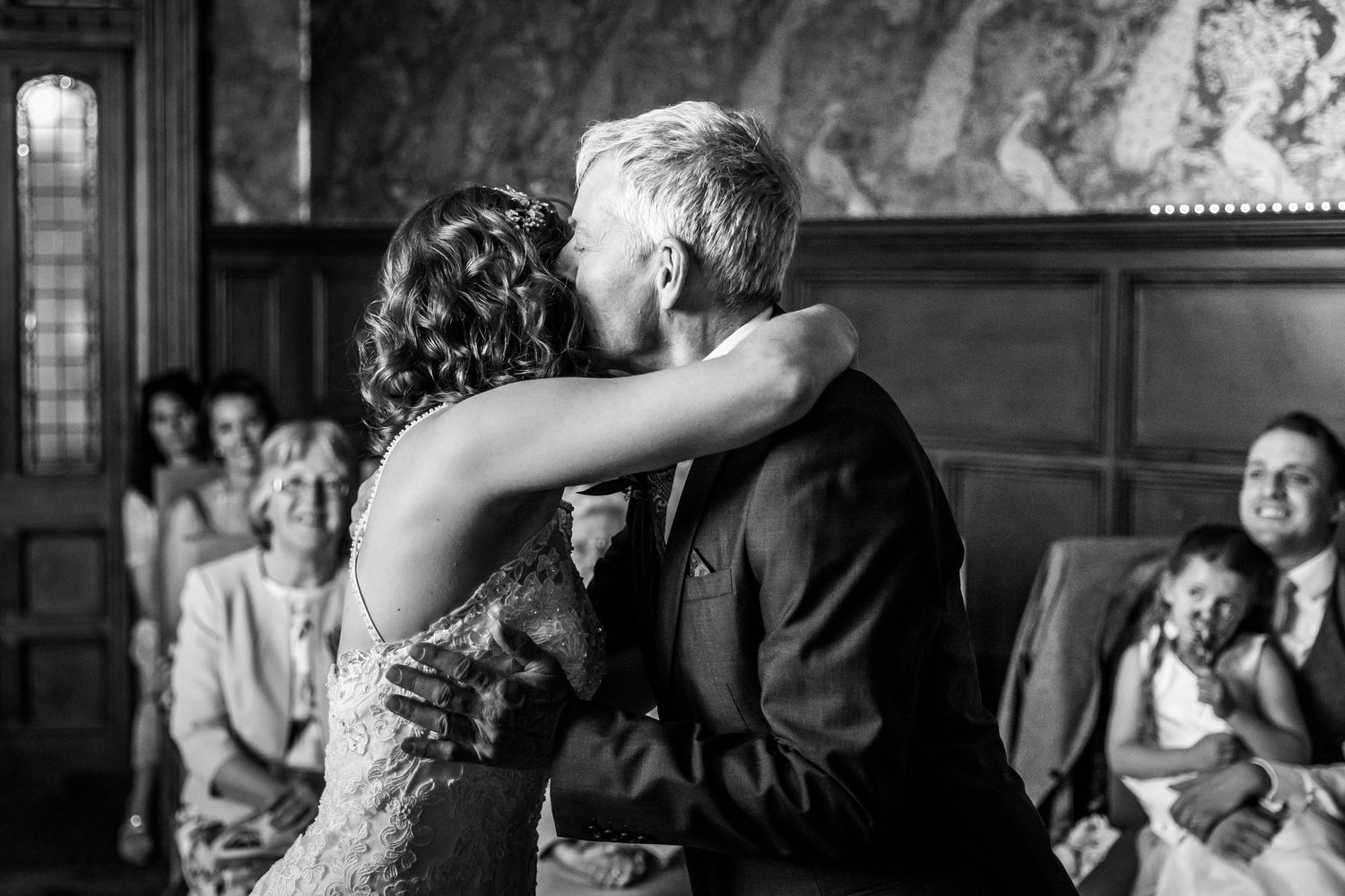 Candid moments captured during an indoor wedding celebration.