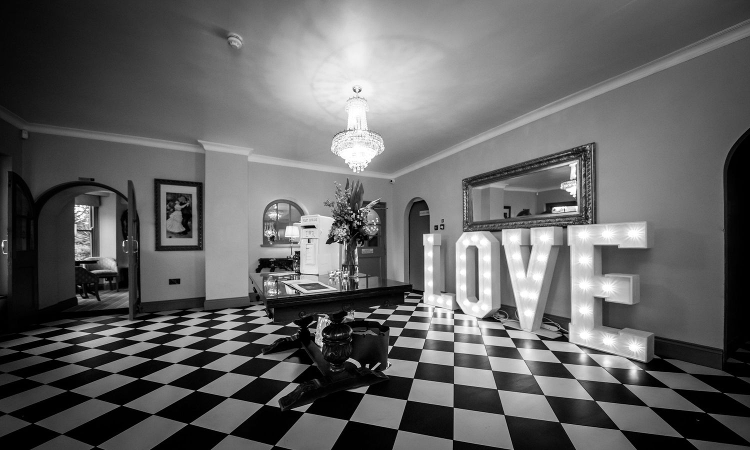 Black and white interior shots of a venue with checkered floor and LOVE sign.