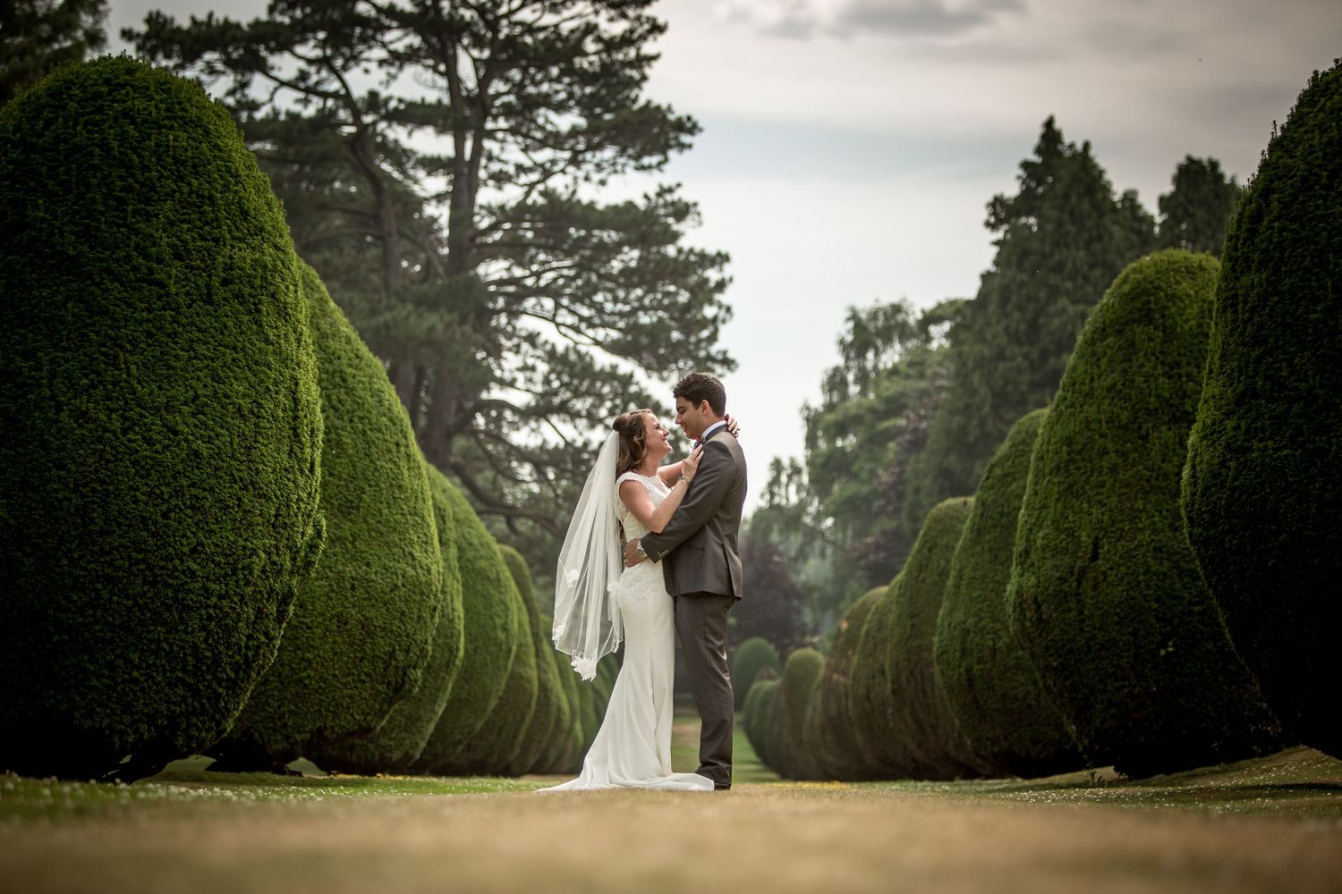 Bride and groom wedding photography in the formal gardens of The Elvetham Hotel, Hampshire wedding venue