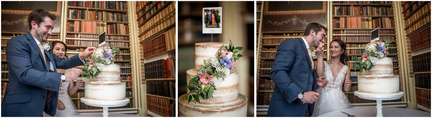 Wedding cake cutting moments captured in an elegant library setting with vintage bookshelves.