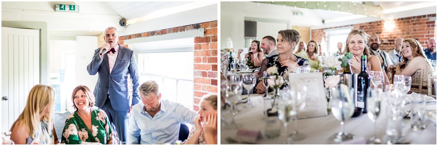 Wedding reception venue with exposed brick walls decorated with white floral arrangements and elegant place settings.