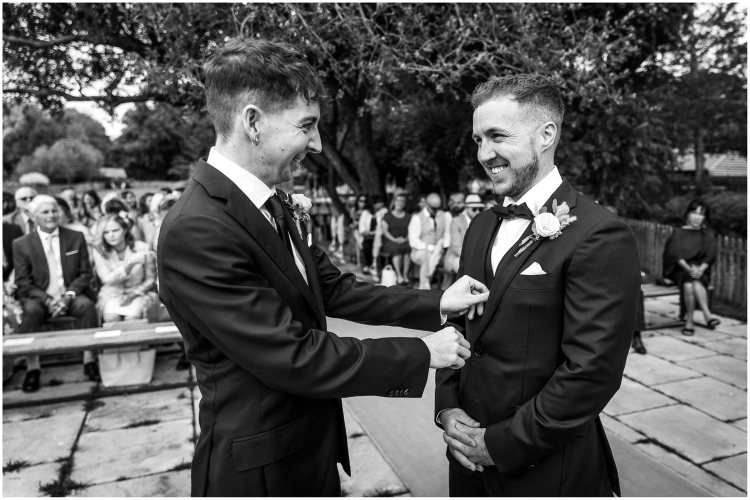 Wedding guests share joyful moments and laughter during outdoor celebration.