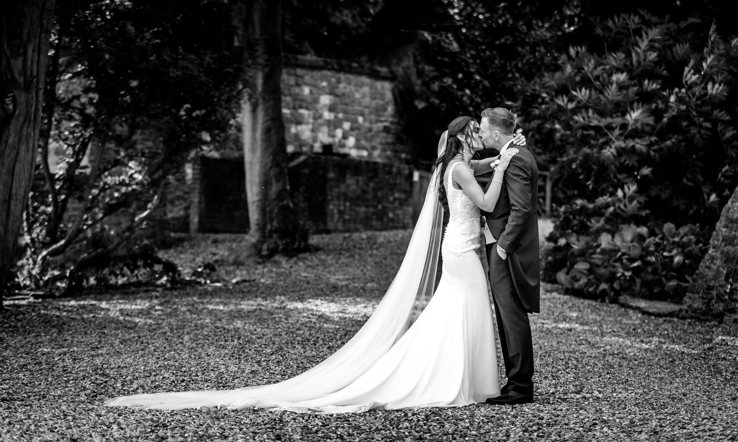 Black and white wedding ceremony photos capturing intimate moments outdoors.