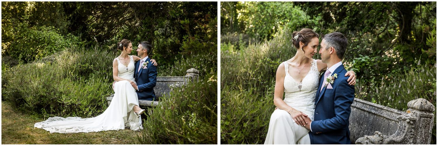 Couple wedding photography portraits by a stone bench in the woodland of Walhampton School in Hampshire