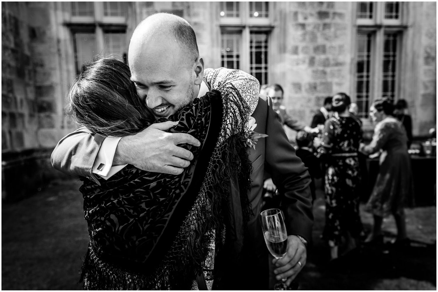 Black and white photos capturing intimate wedding moments against stone architecture.