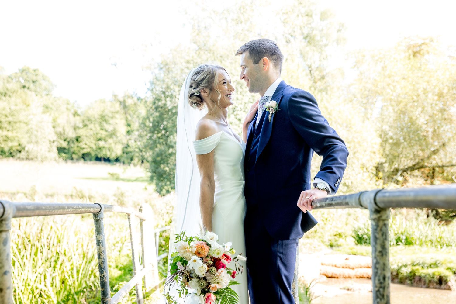 Sunlit garden wedding portraits with soft golden hour lighting.