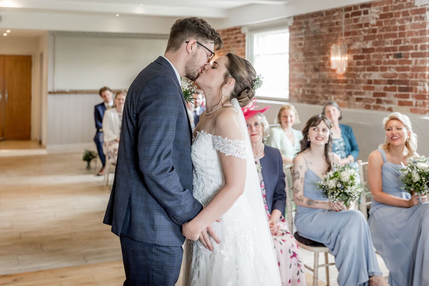 Wedding ceremony proceedings in an industrial-chic venue with exposed brick walls.