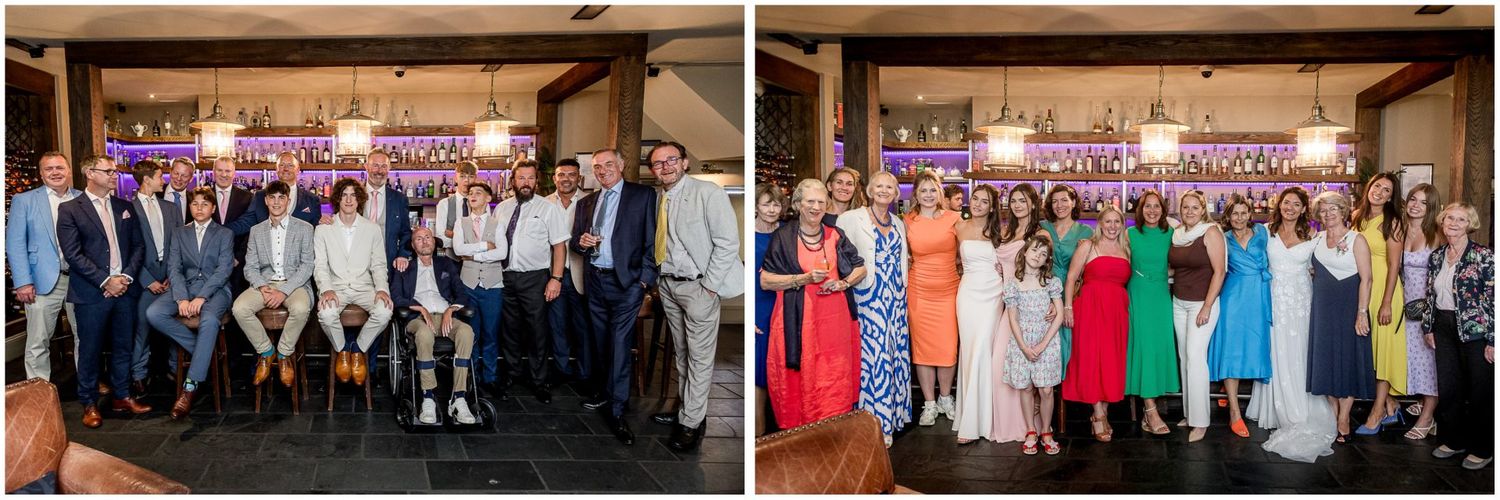 Large group photo of wedding guests gathered together at an indoor venue.