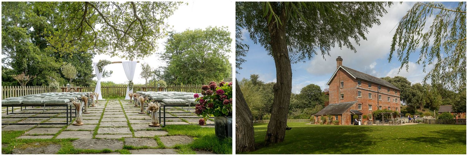 Outdoor wedding venue featuring a stone pathway leading to an arch and rustic red barn in countryside setting.