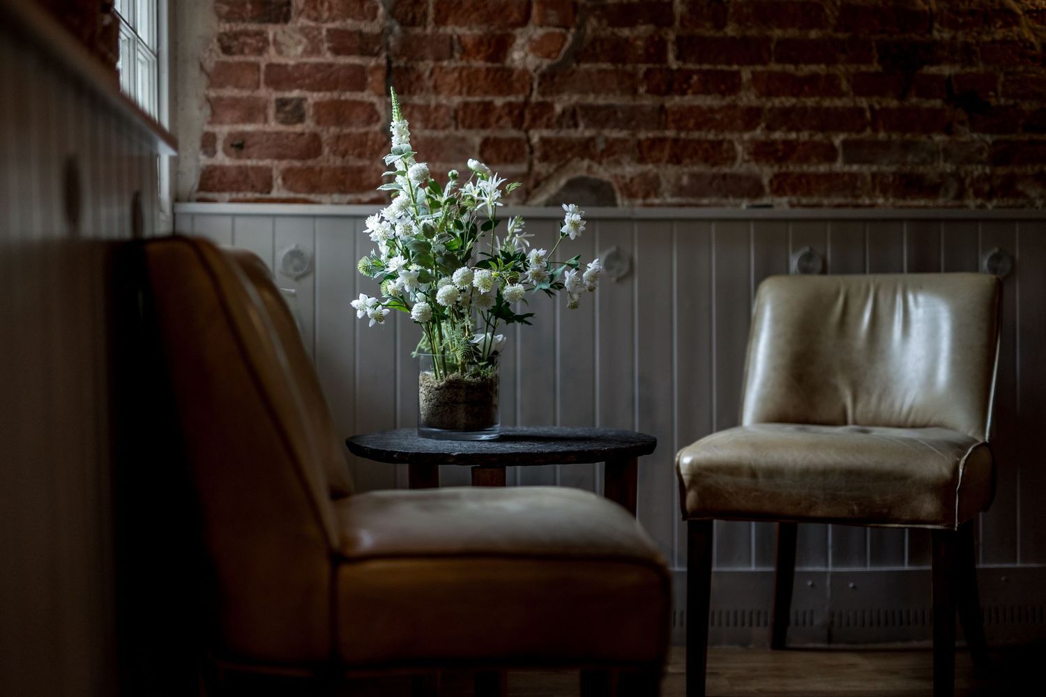Modern wedding venue interior with exposed brick walls and elegant lounge furniture.