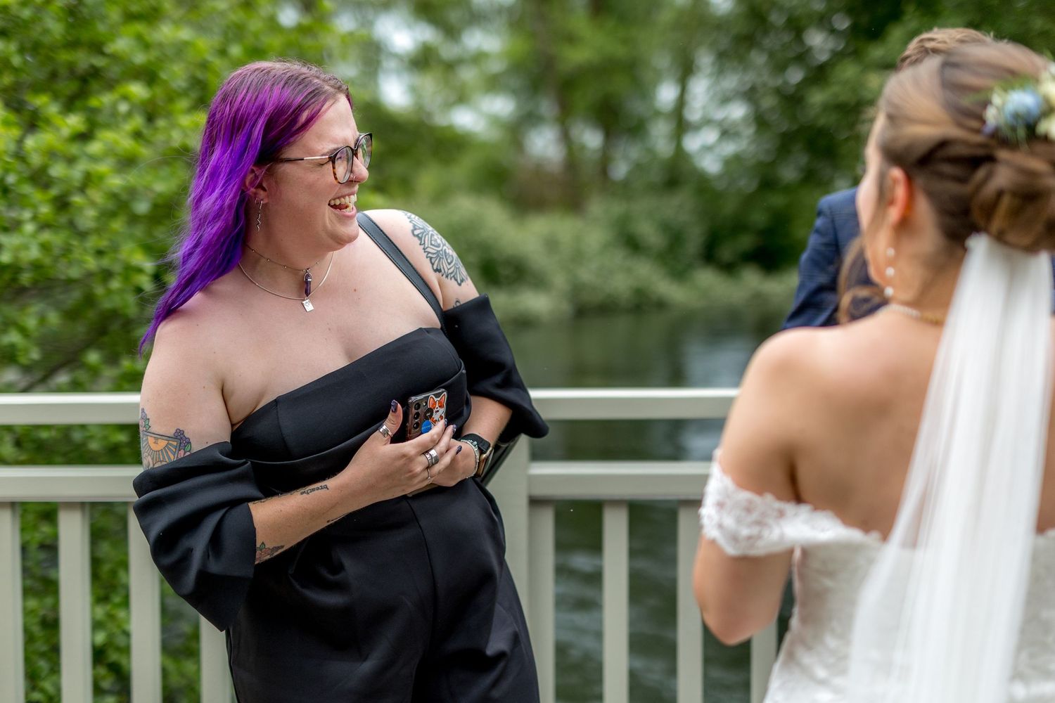Guests sharing embraces and congratulations during an outdoor wedding reception.