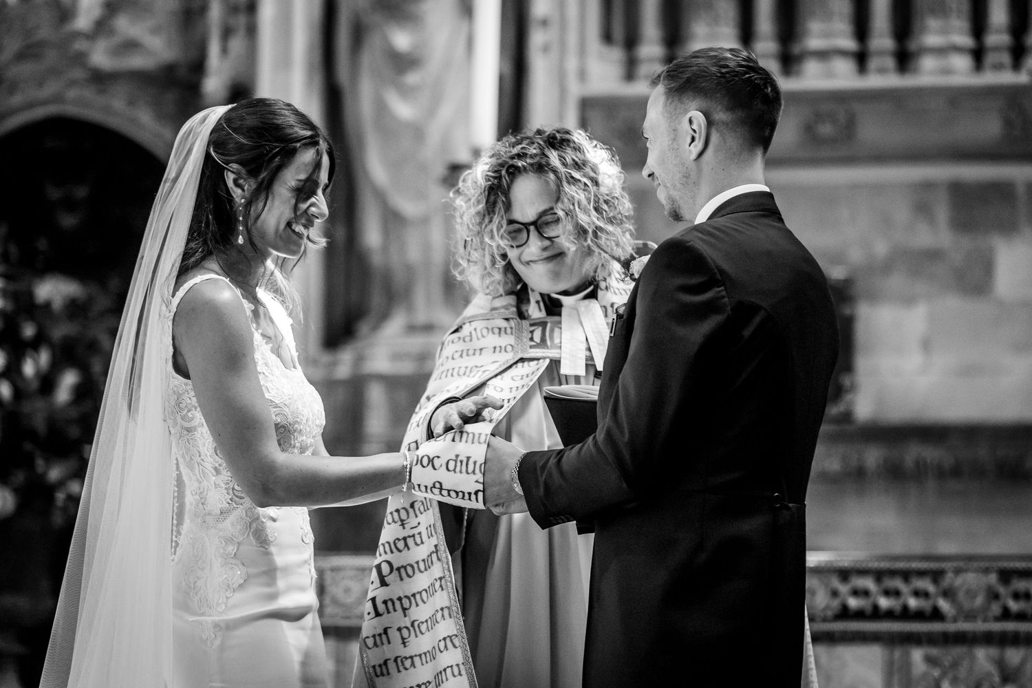 Intimate wedding ceremony moment captured in black and white photography.