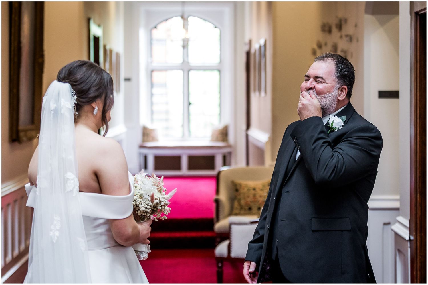 Father of the bride sees his daughter in her wedding dress for the first time - reaction shot