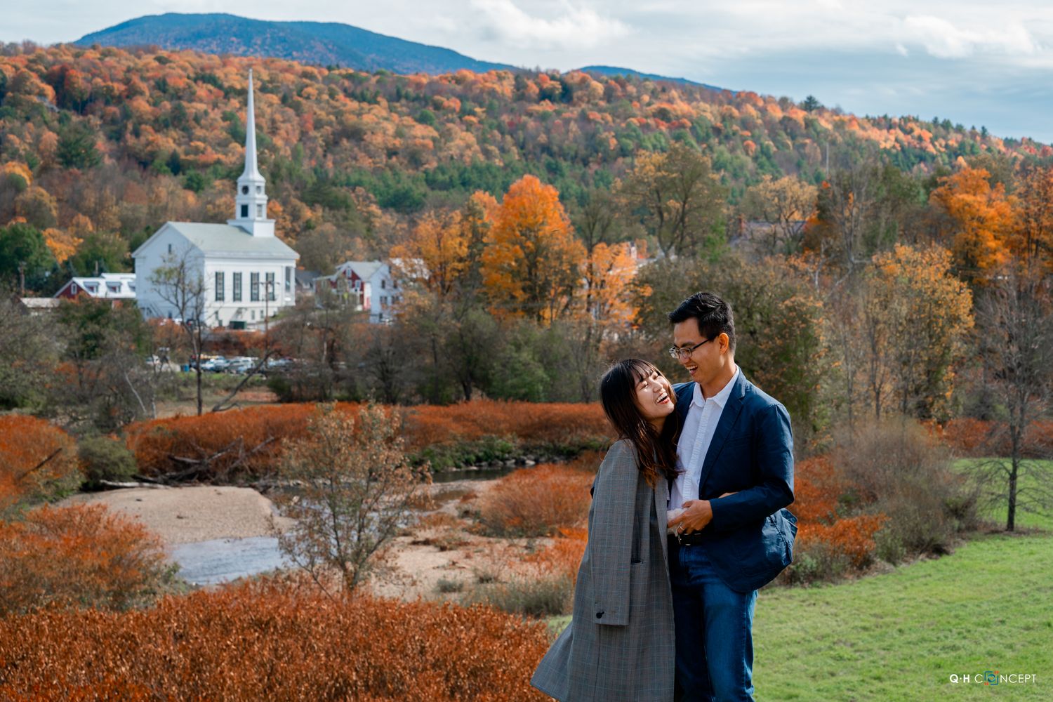 Romantic autumn photoshoot with mountain landscape and white church steeple in background.
