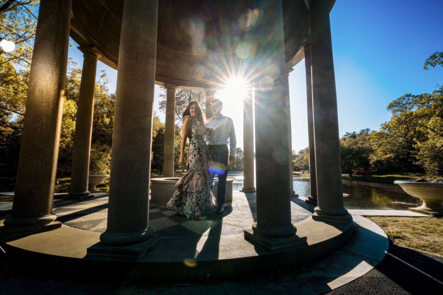 Sunlight streams through pillars creating dramatic shadows and light patterns.