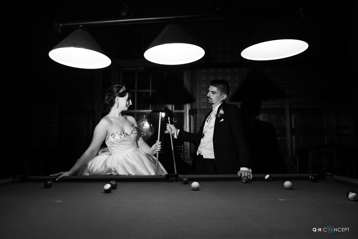 Black and white billiards game scene with dramatic lighting.
