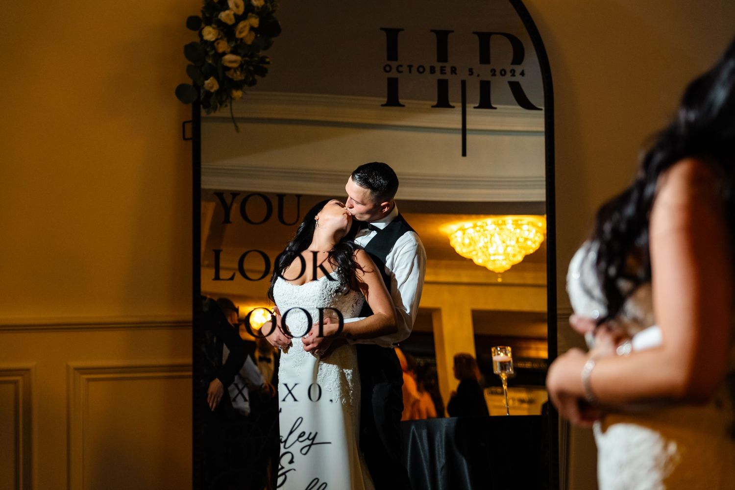Dark and moody reception venue lighting with decorative elements and signage.