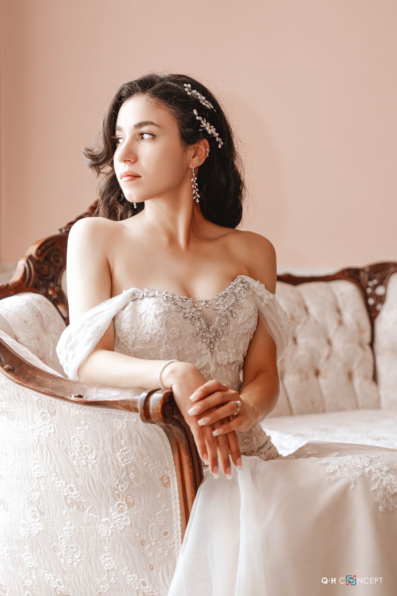 Soft, dreamy bridal portraits on a vintage sofa showcasing an embellished white wedding dress.