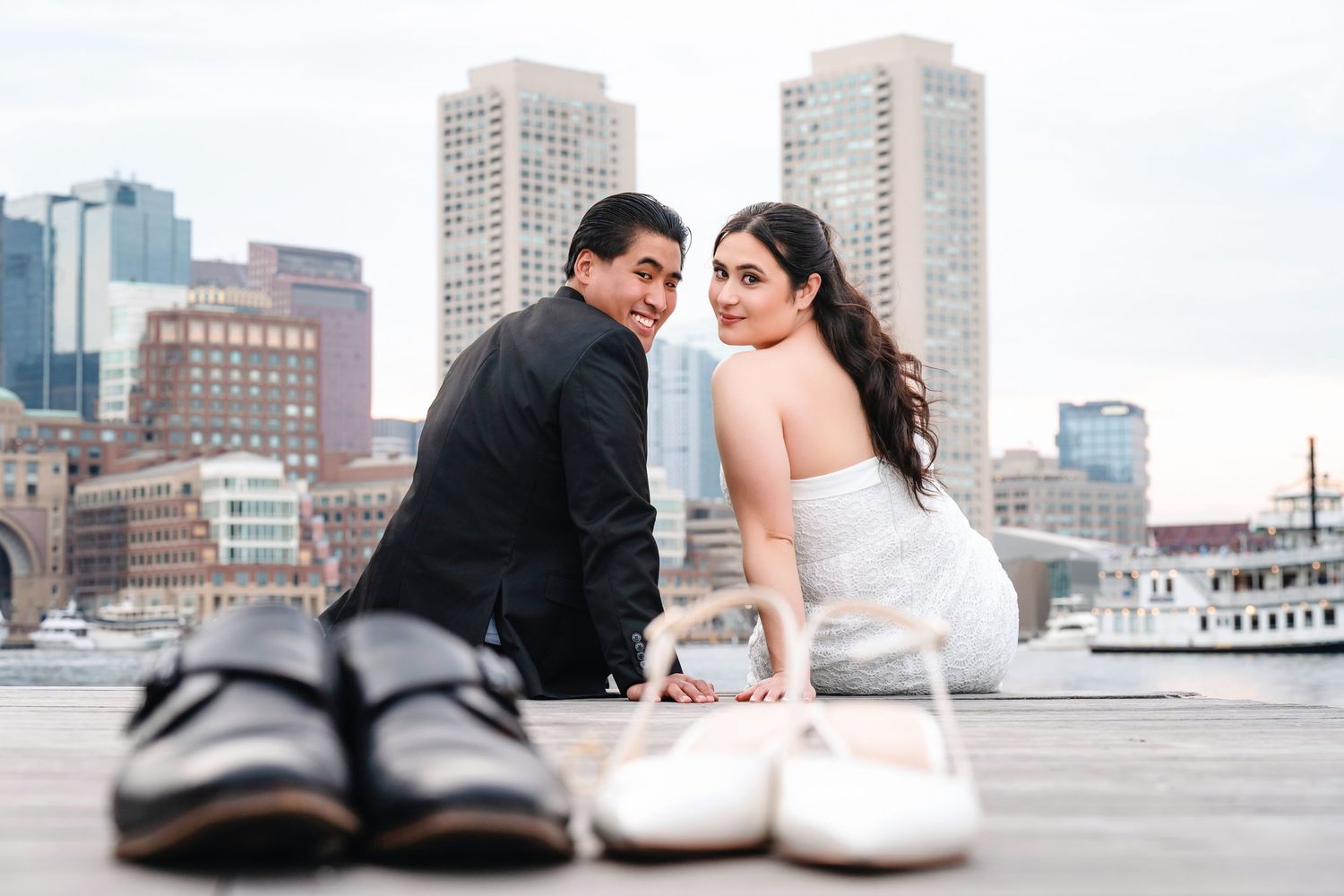Urban wedding photography with Boston skyline and harbor views in the background.