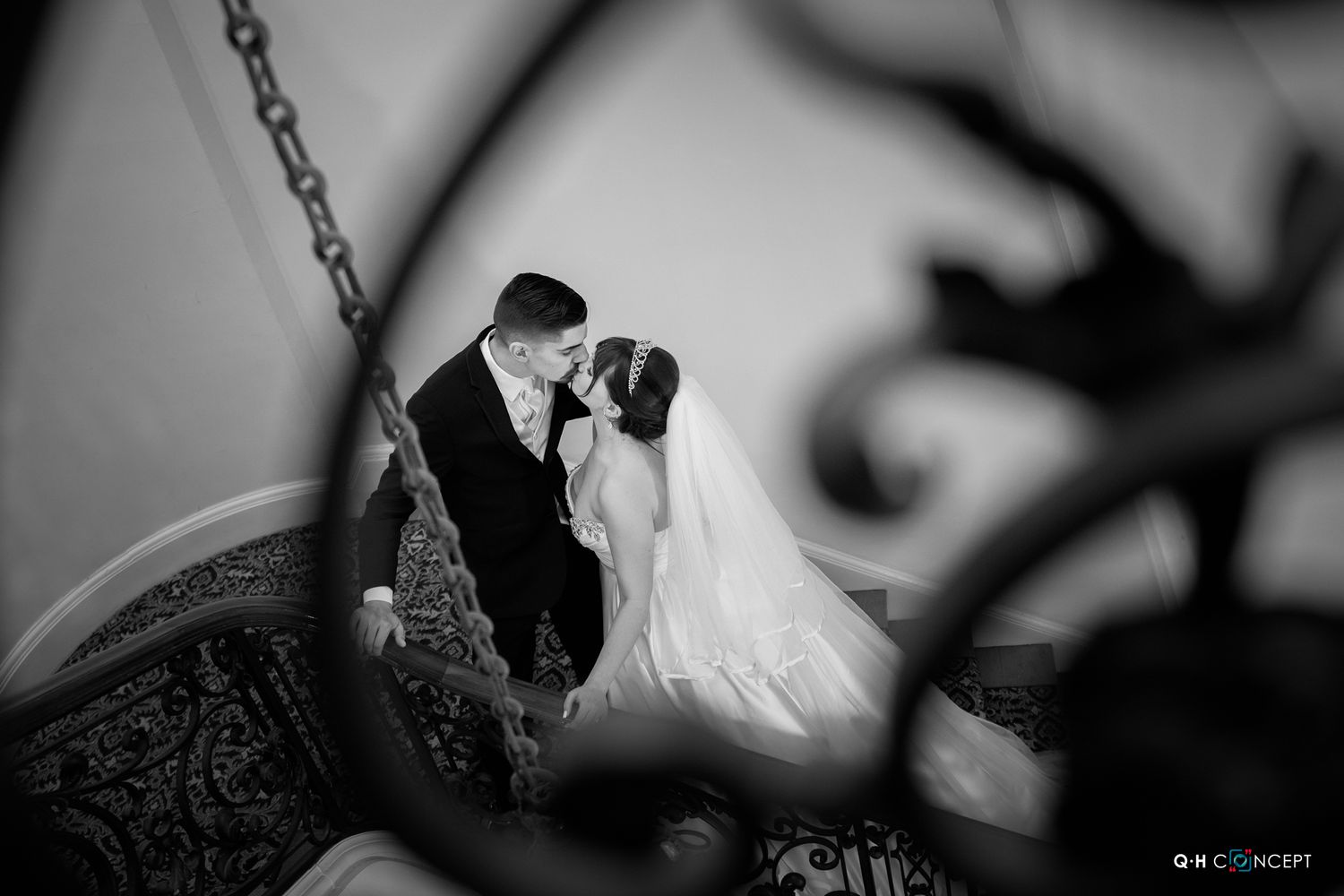 A dramatic black and white wedding photo with creative shadows and lighting effects.