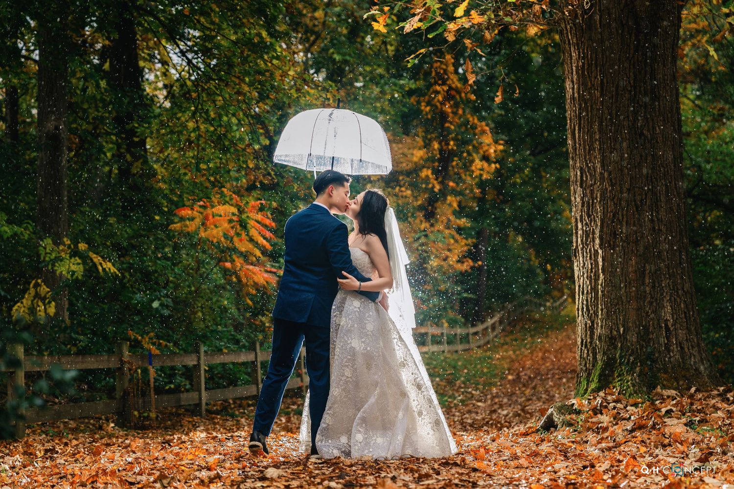 An autumn engagement session in a park with fallen leaves and natural lighting.
