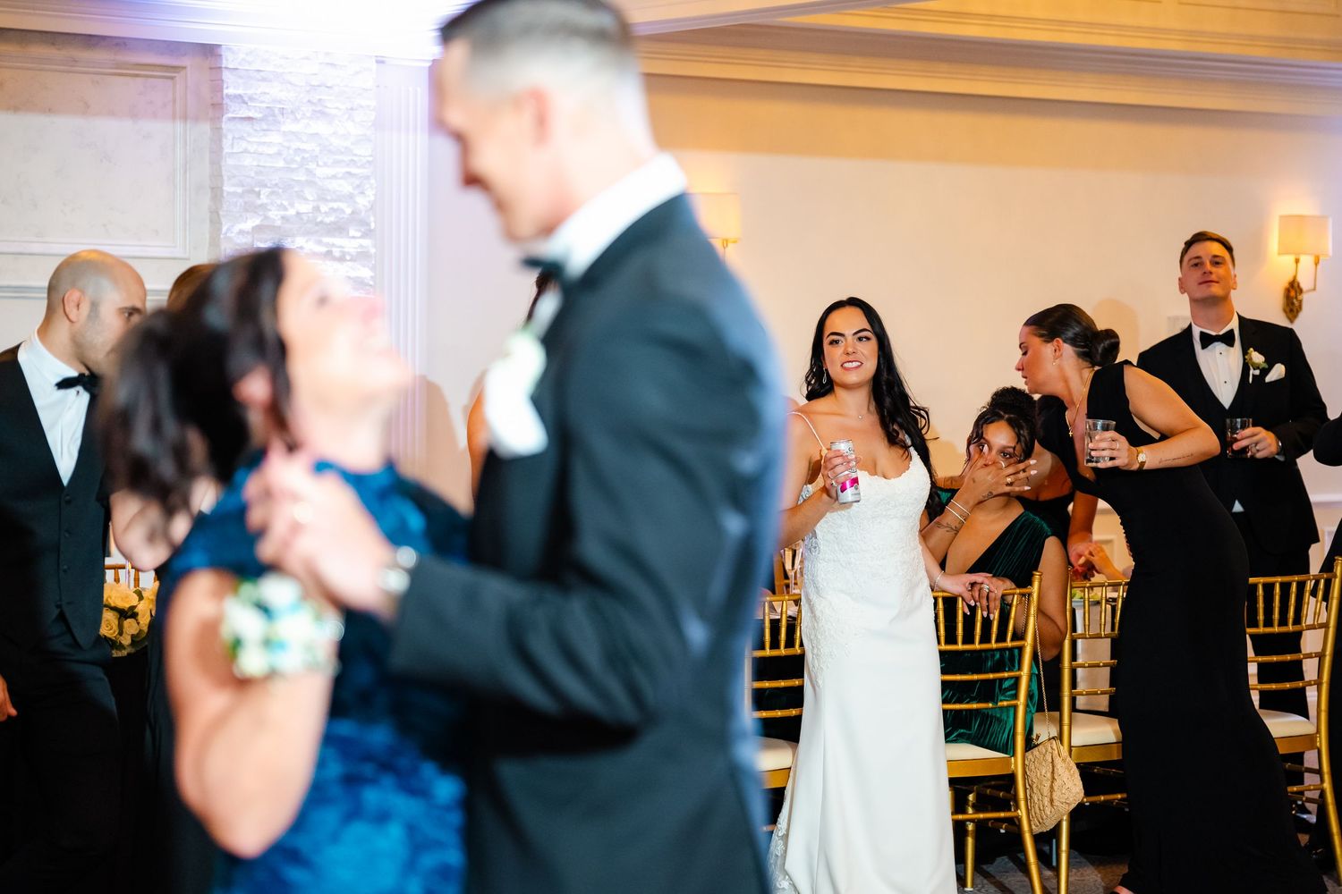 Couples dancing together at an elegant wedding reception in formal attire.