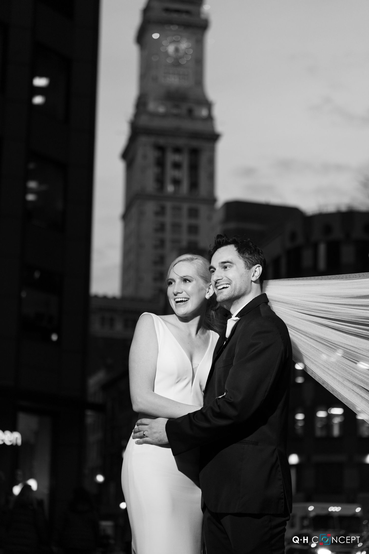 A romantic black and white wedding photo sequence showing a couple with flowing veil against a city skyline at night.