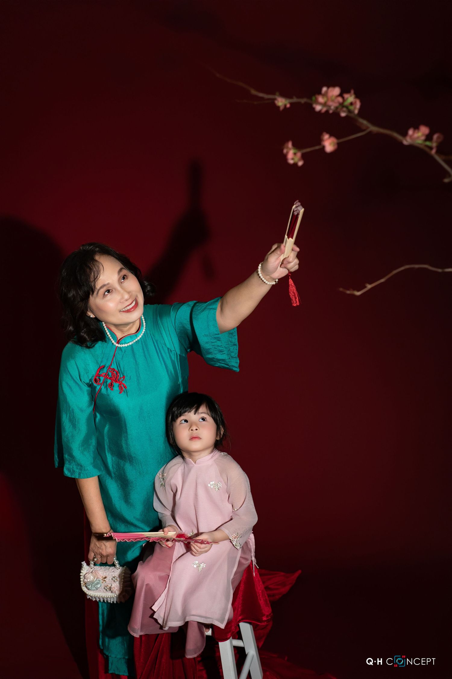 A photo series showing a traditional Chinese New Year celebration scene with cherry blossoms against a deep red background.