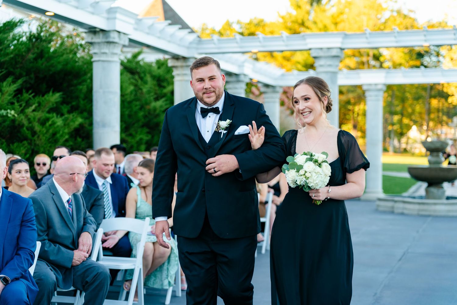 A series of candid moments from a formal outdoor wedding celebration at sunset with guests gathered around columns.