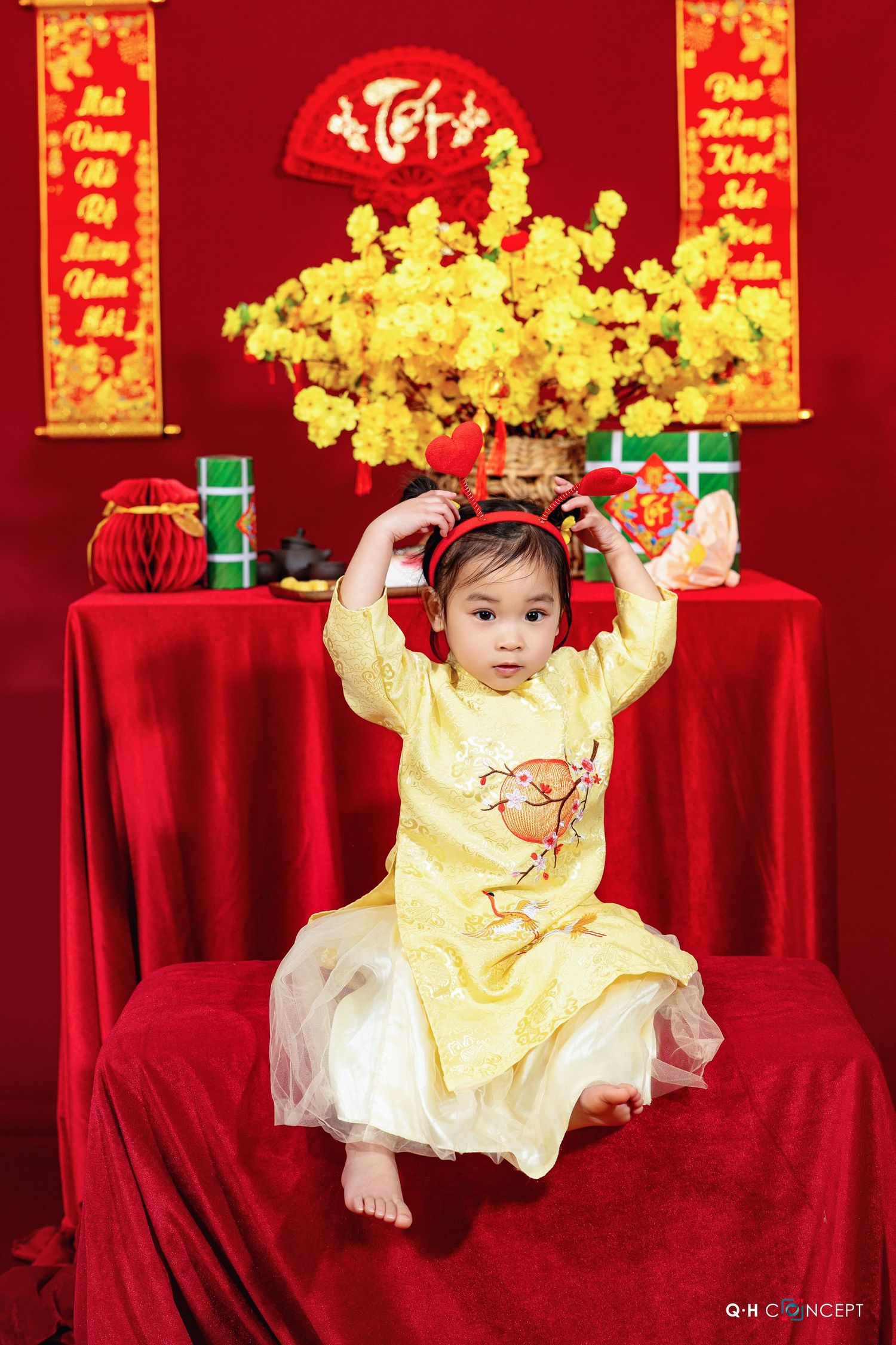 Traditional Chinese New Year setup with red backdrop and golden decorative elements.
