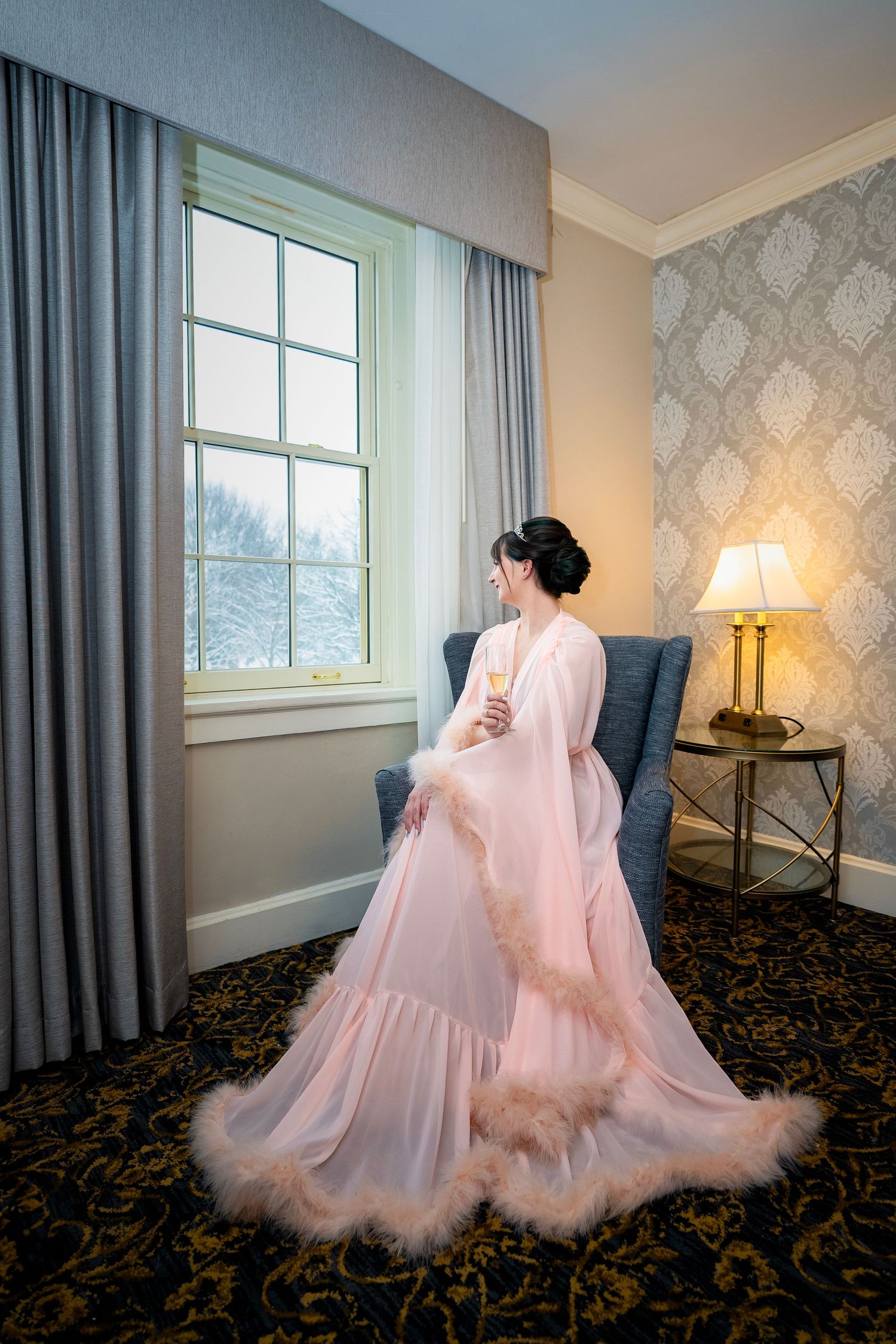 A flowing pink tulle dress twirls gracefully in a room with blue curtains and patterned carpet.